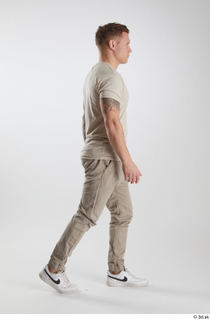 Gilbert 1 dressed grey t-shirt grey trousers side view walking…